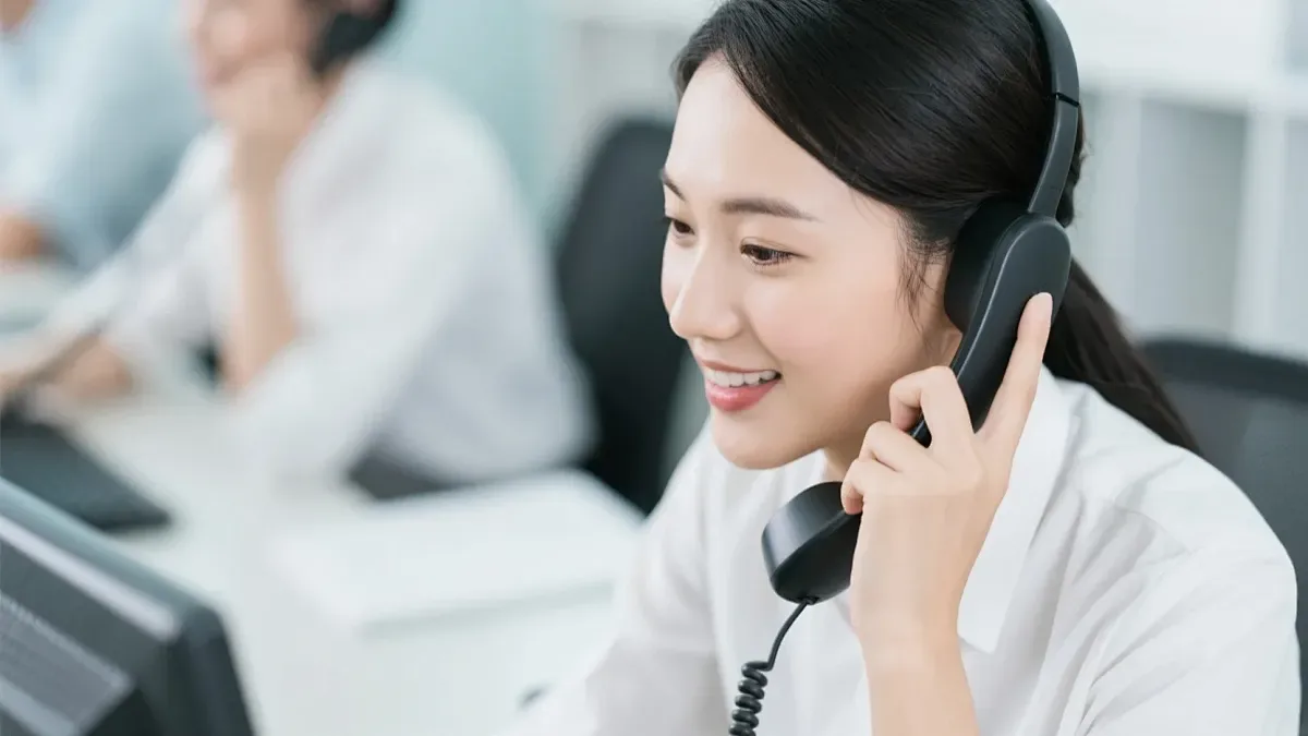 Customer support specialist answering a project inquiry on a headset